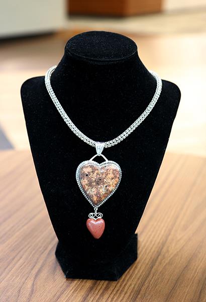sterling silver necklace with hand-carved rocks hanging from it